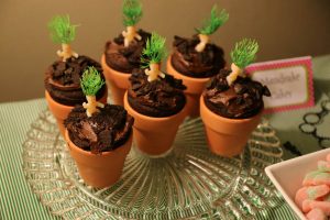 Mandrake babies. Tiny toy babies with green plant-like hair "growing" in a little flower pot