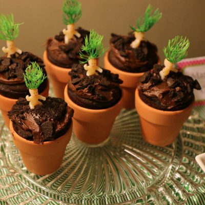 Mandrake babies. Tiny toy babies with green plant-like hair "growing" in a little flower pot